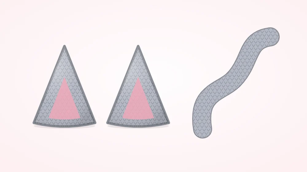 Two small crocheted cones pressed flat into pointed cat ears beside a long narrow crocheted tail tube