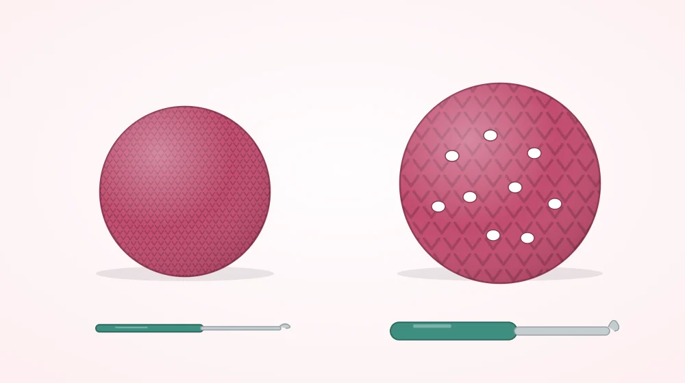 Two crocheted balls in the same yarn, a dense one beside a thin hook and a loose one with white stuffing showing through beside a thick hook