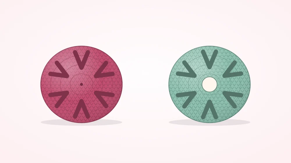 Two small six-stitch crocheted circles side by side, one with a fully closed center and one with a small hole in the center