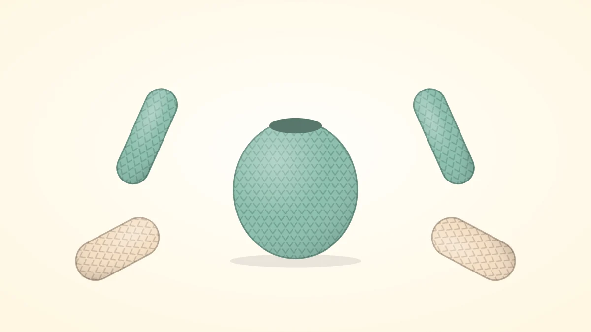 Two crocheted arms and two crocheted legs, tubes with rounded ends, laid out around a small body piece