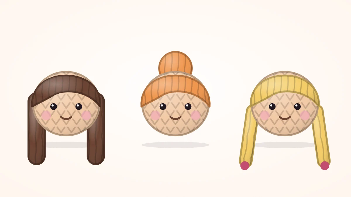 Three crocheted doll heads in a row with long loose hair, a top bun and two braids