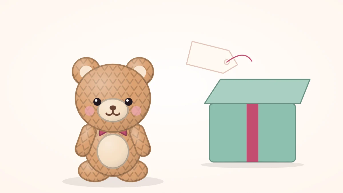 Crocheted bear with a ribbon bow around its neck sitting beside a small open gift box and a blank gift tag