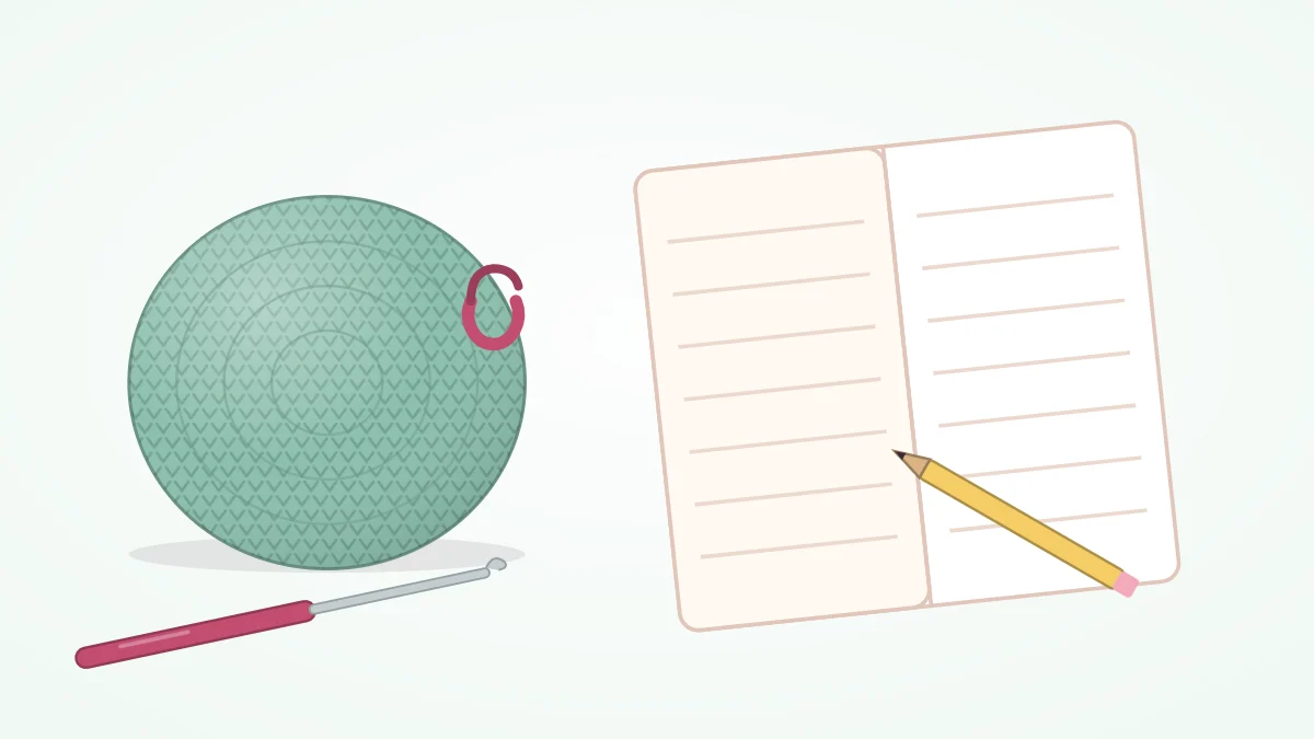 A flat crocheted circle with a stitch marker clipped to it and a crochet hook, lying next to an open blank notebook and a pencil