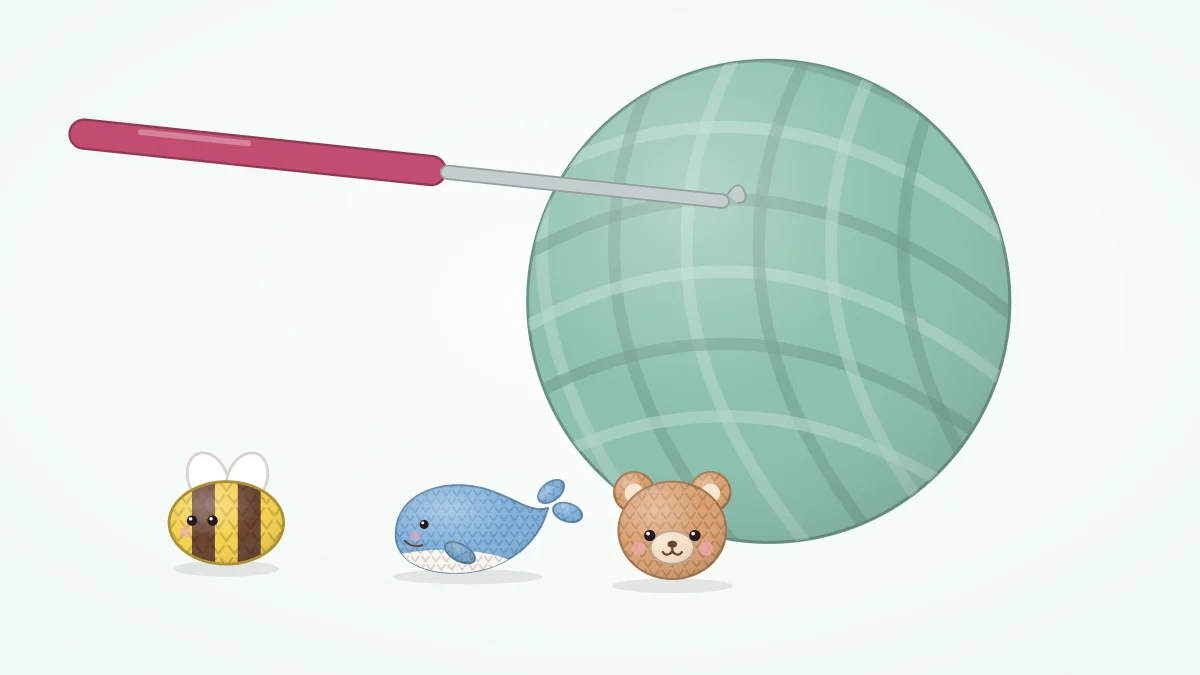Three tiny crocheted creatures, a bee, a whale and a bear head, sitting in front of a much larger ball of yarn and a crochet hook
